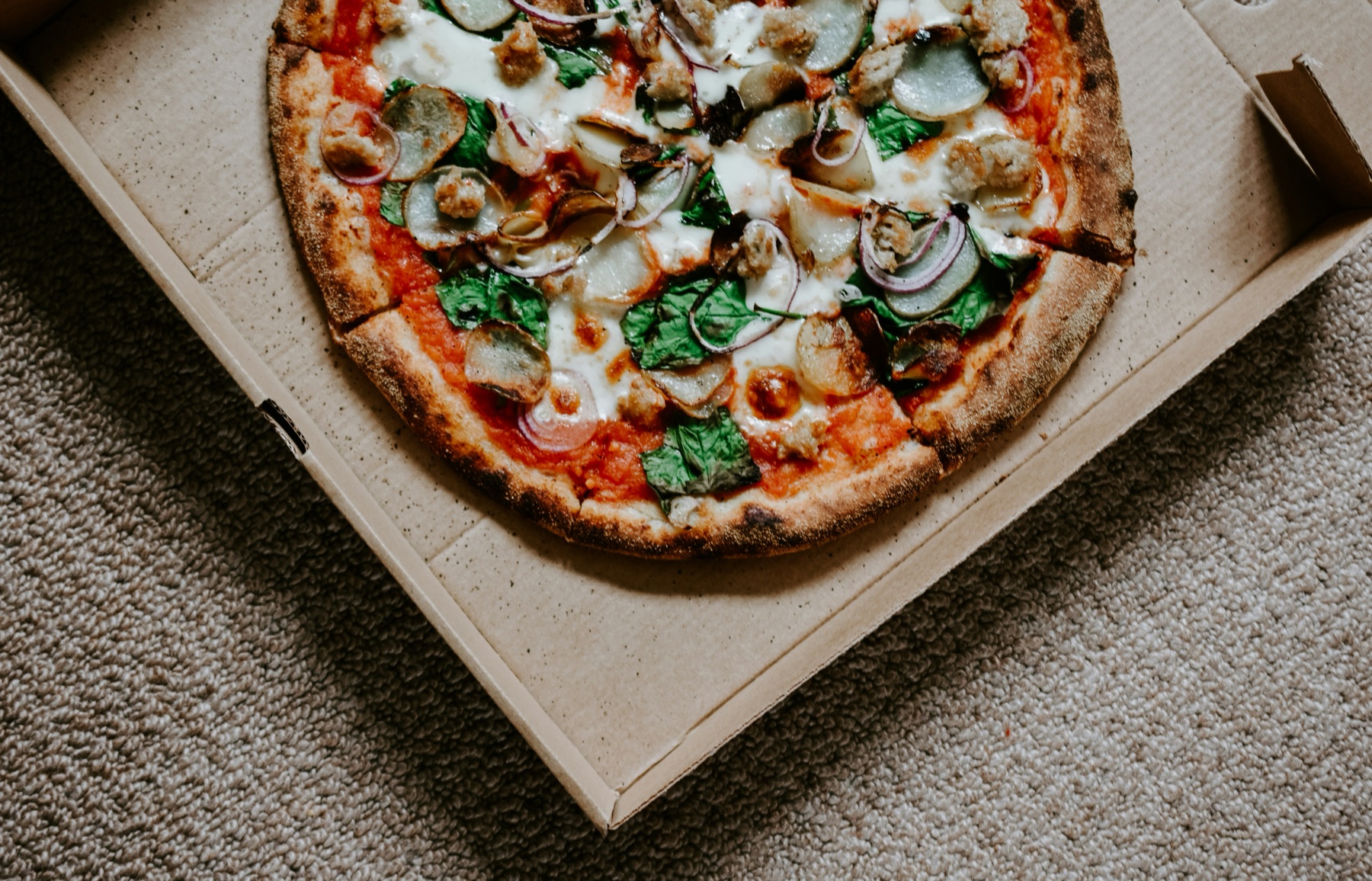Freshly cooked pizza served in a takeaway box